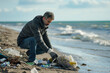 environmentalist man collects garbage on the beach 