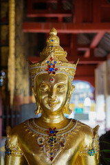 Wall Mural - Golden Buddha Statue in Thailand's Ancient Temple