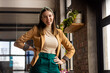 © Wavebreak Media - Young Caucasian woman poses confidently in a casual business setting in a modern office