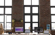 © Wavebreak Media - A modern casual business office setup with large windows and multiple monitors