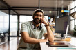 © Wavebreak Media - Young Asian man smiles at his desk in the office, dressed for casual business