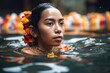 cropped shot of a young woman in a pool of water at the temple during songkran