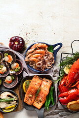 Canvas Print - Set of Seafood dishes on light wooden background.