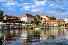 View Of The Center Of Ryn, The Castle, The Lake And The Marina With Moored Boats., Masuria, Poland.