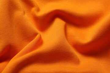 Wall Mural - Texture of orange crumpled fabric as background, top view