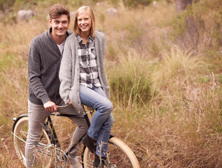 Poster - Couple, portrait and field with retro bicycle on holiday, adventure or date with sustainable transport. Man, woman and vintage bike with smile for vacation with journey in nature, path or environment