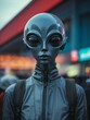© rokr81design - grey alien in public photography. alien wearing zip top and backpack