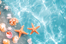 Orange Starfish And Assorted Shells Float On A Tranquil, Crystal-clear Blue Water Surface With Light Reflections