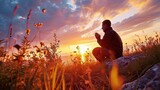 Fototapeta Tulipany - Christian prayer. Man on his knees praying on sunset background. Kneeling prayer to God.