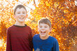 © Austockphoto - Portrait of young brothers laughing together in autumn