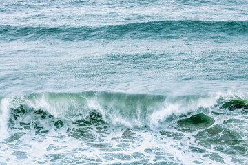 Wave splashing close-up. Crystal clear sea water, in the ocean in San Francisco Bay, blue water, pastel colors.