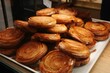 © Wirestock - Closeup of freshly-baked Kouign-amann on a tray on the table