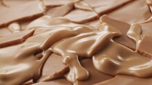 Molten Caramel Gushing Through The Cracks Of Broken Caramel Chocolate Surface
