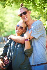 Sticker - Portrait, smile and couple hug at music festival, event and celebration on valentines day together in summer. Face, man and happy woman in sunglasses, embrace and party outdoor for love in nature