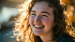 © DJSPIDA FOTO - Close-up portrait of a cheerful young woman with sun-kissed curly hair and a bright smile