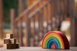 © Austockphoto - Brightly coloured wooden rainbow learning puzzle in nature-based playground environment