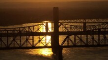 Drone Footage Of A Bridge On A Sea Against Yellow Sunset Sky