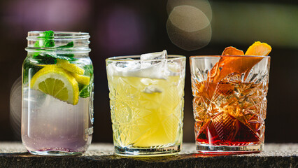 three different alcoholic cocktails with old-fashioned glasses