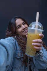 Wall Mural - Portrait of cheerful young woman holding bubble tea