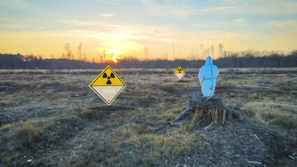 Virologist wearing hazard protective suite and gas mask on contaminated land after using Biological weapons