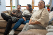 © Cultura Creative - Smiling three-generation family watching TV