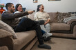 © Cultura Creative - Smiling three-generation family watching TV