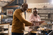 © Cultura Creative - Senior couple preparing food in kitchen