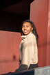 © Cultura Creative - Portrait of smiling woman at red wall