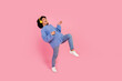 Full size photo of pretty young girl play invisible guitar headphones wear trendy blue knitted outfit isolated on pink color background