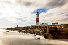 Breathtaking View Of The Portland Bill Lighthouse In The Stunning Landscape With The Body Of Water