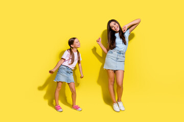 Canvas Print - Photo of two positive girls older sister dancing teaching younger isolated over vivid color background