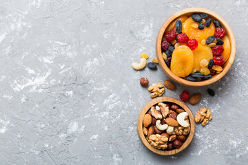 Wall Mural - healthy snack: mixed nuts and dried fruits in bowl on table background, almond, pineapple, cranberry, cherry, apricot, cashew