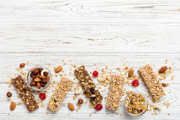 Wall Mural - Various granola bars on table background. Cereal granola bars. Superfood breakfast bars with oats, nuts and berries, close up. Superfood concept