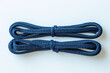 Two new shoelaces on white, dark-blue laces, top view.