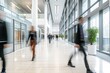 Bright business workplace with people walking in blurred motion in modern office building