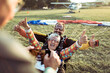 © Marko Geber - Happy senior woman landing with skydiving instructor