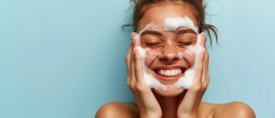 Joyful woman with foam on face, experiencing the bliss of skincare