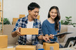 © NINENII - Couple start up small business owner at workplace. small business entrepreneur SME or freelance asian woman working with box at home.