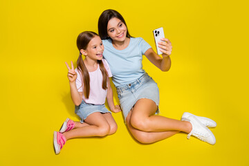 Wall Mural - Photo of best siblings selfie photographing make v sign isolated over vivid color background