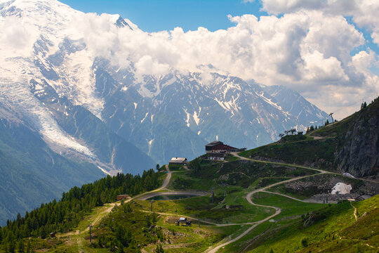 Picturesque panoramic view of the snowy Alps mountains and meadows while hiking Tour du Mont Blanc. Popular hiking route. Alps, Chamonix-Mont-Blanc region, France, Europe.