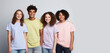 © FoxTok - Group of happy multiracial teenage school students on gray background. Young people of different races, ethnic groups, different skin colors. Friendship, learning, education concept