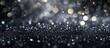 A glittering black background resembling a drizzling cloudy sky or a wet asphalt road surface, with a touch of moisture and liquid-like texture.