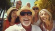© Yauhen - Senior Friends Enjoying Outdoor Selfie - Pensioners Smiling, Embracing Summer Holiday Fun - Lifestyle Concept of Elderly Friendship and Joyful Moments Captured with Smartphone,