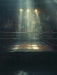 An empty boxing ring in a gym under a spotlight, conveying anticipation and the silent preparation before a fight or training session.