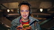 Brunette listening music wireless headphones at night walk close up. Happy woman