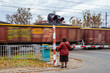 person waiting at train crossing to pass 