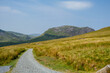 Mountain road / path in the mountains during summer day, Scotland or Wales 