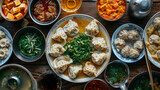 Fototapeta  - a table topped with plates of dumplings and bowls of soup