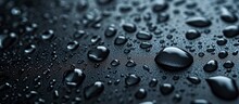 A Close-up Of Water Drops, Liquid, Or Moisture On A Black Surface, Showcasing The Beauty Of Tiny Droplets.