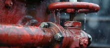 A Detailed Image Of A Red Fire Hydrant With Water Flowing Out, Featuring A Vehicle-related Element In Its Surroundings